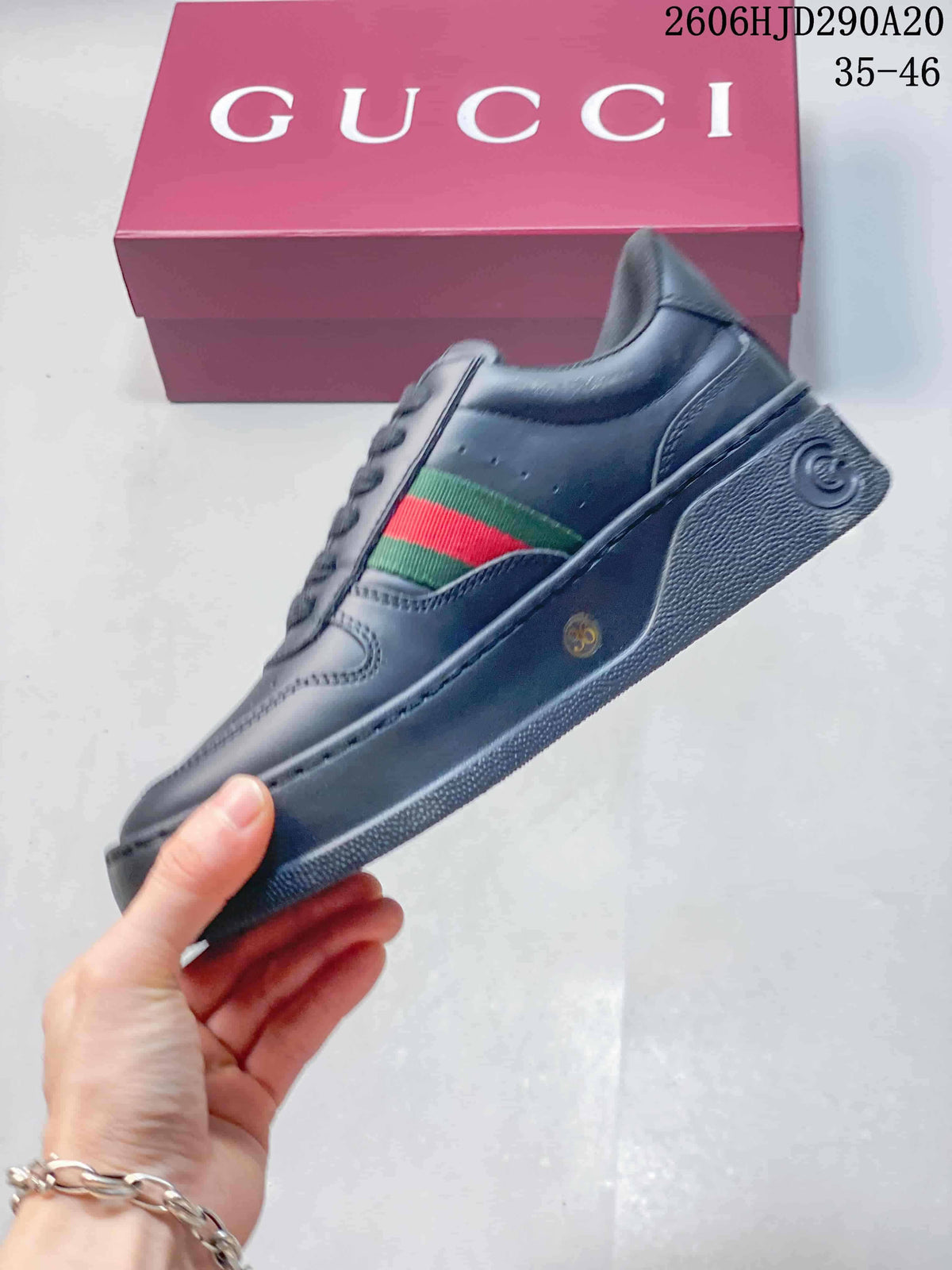 Side view of the dark sneaker with a green-and-red stripe and raised sole