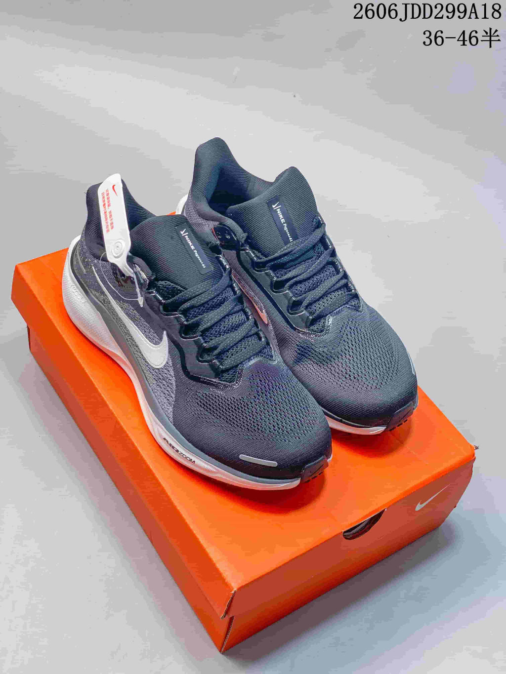 Pair of dark gray Nike Pegasus 41 running shoes on an orange shoe box