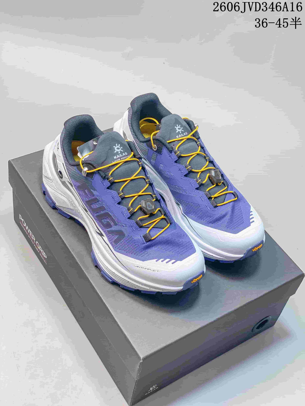 Pair of purple, white, and gray Kailas FUGA EX3 trail running shoes with yellow laces