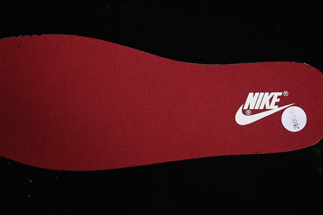 Burgundy insole with a Nike logo and size sticker