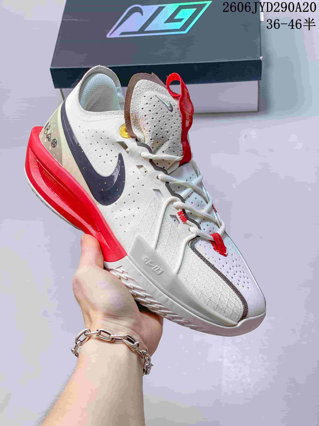 Angled side view of the white basketball shoe with red and dark accents