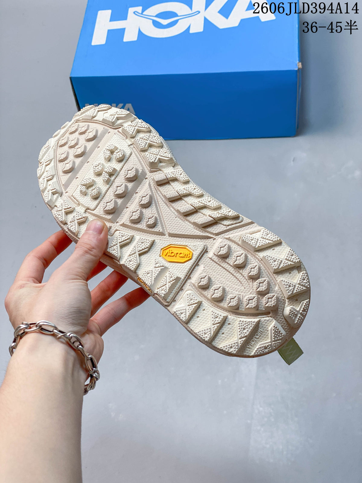 Close-up of the cream-colored patterned outsole with a yellow Vibram badge