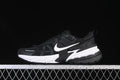 Side view of black Nike V2K Run shoes with a white Swoosh and two-tone sole.
