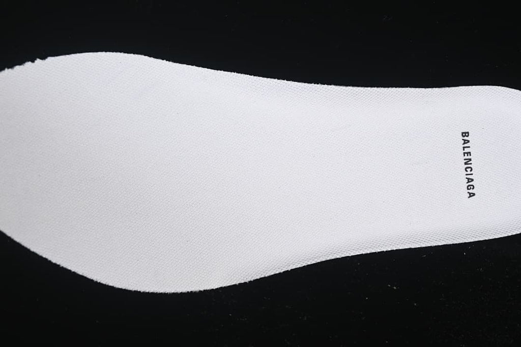 Close-up of a white insole with Balenciaga branding.