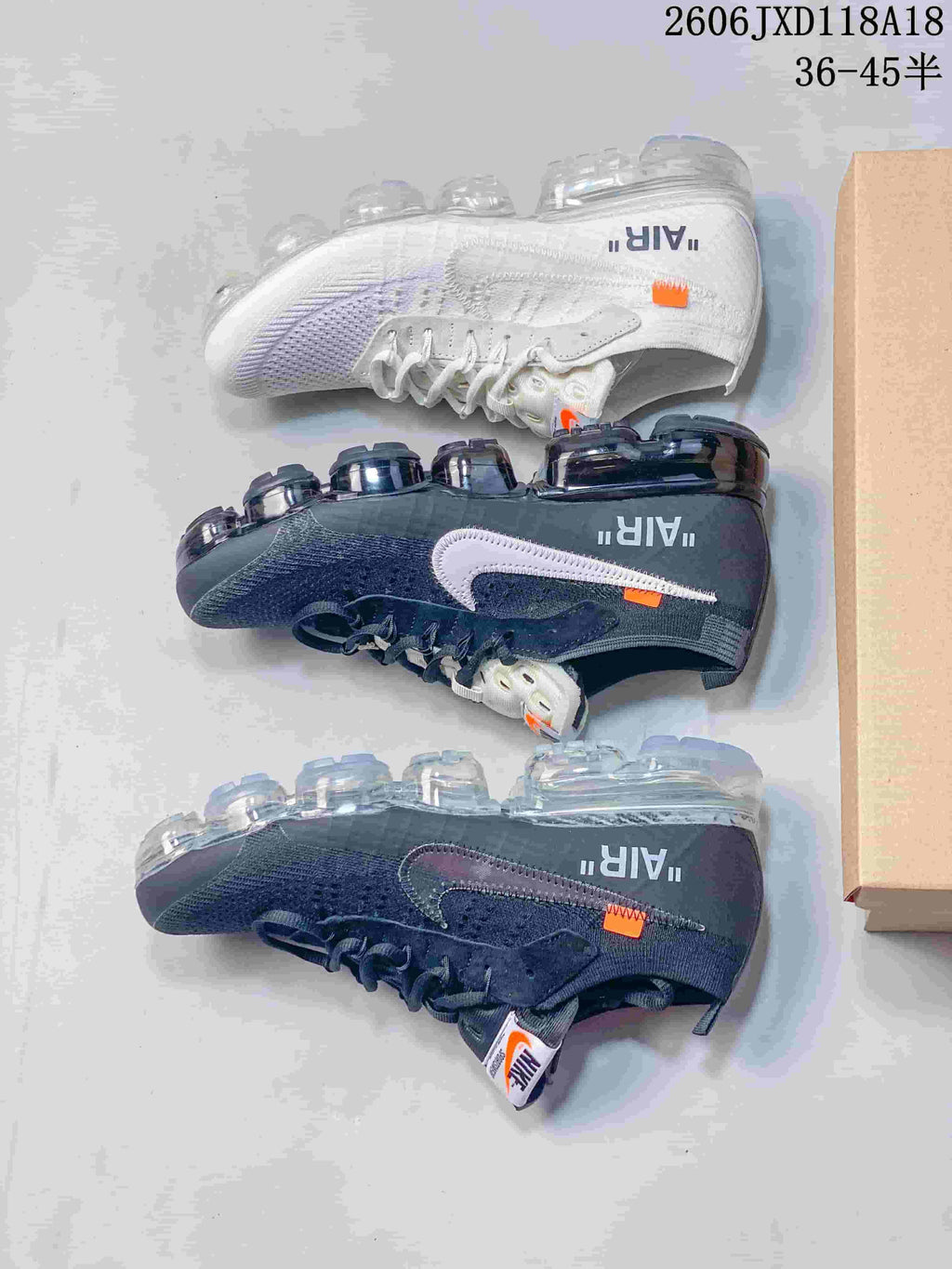 Dark gray and white sneakers shown side by side, with contrasting Swoosh details and segmented soles.