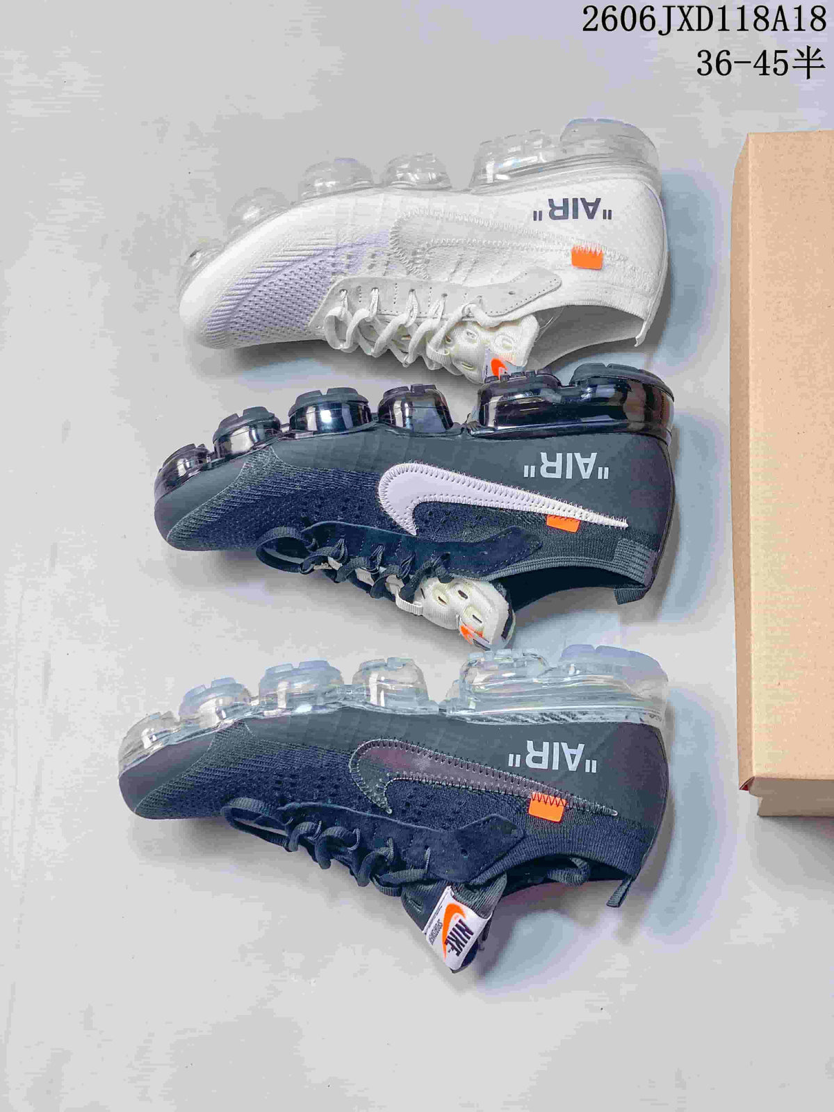 Dark gray and white sneakers shown side by side, with contrasting Swoosh details and segmented soles.