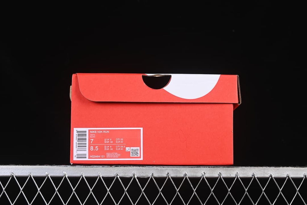 Red shoe box label showing Nike V2K Run and size information.