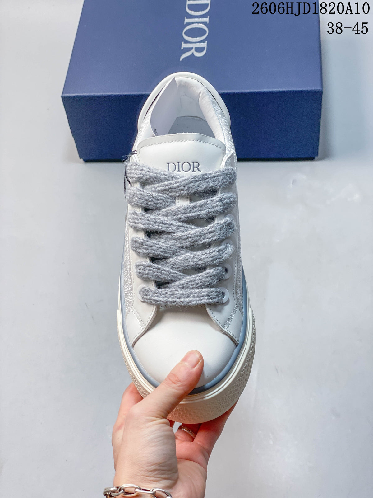 Top view of a Dior B33 sneaker showing its padded tongue and thick gray laces
