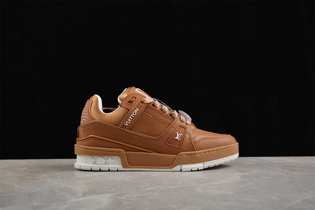 Angled side view of the brown sneaker with a white heel outsole section.