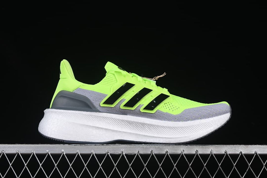 Outer side view of the lime green and gray running shoe