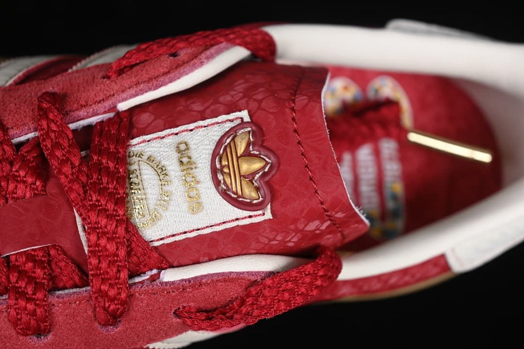Close-up of the sneaker tongue label, red laces and patterned upper