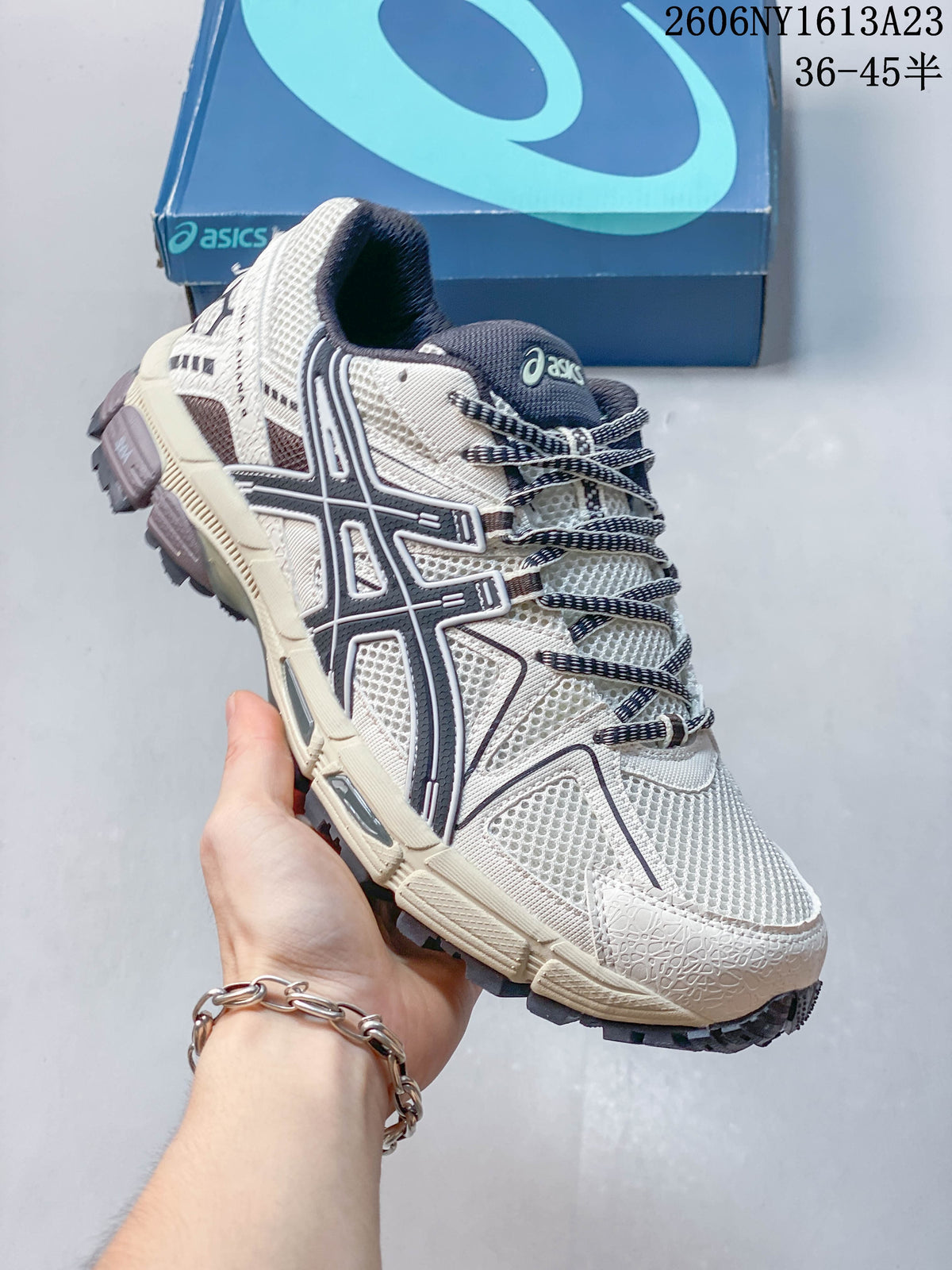 Angled side view of a cream and navy ASICS Gel-Kahana 8 shoe