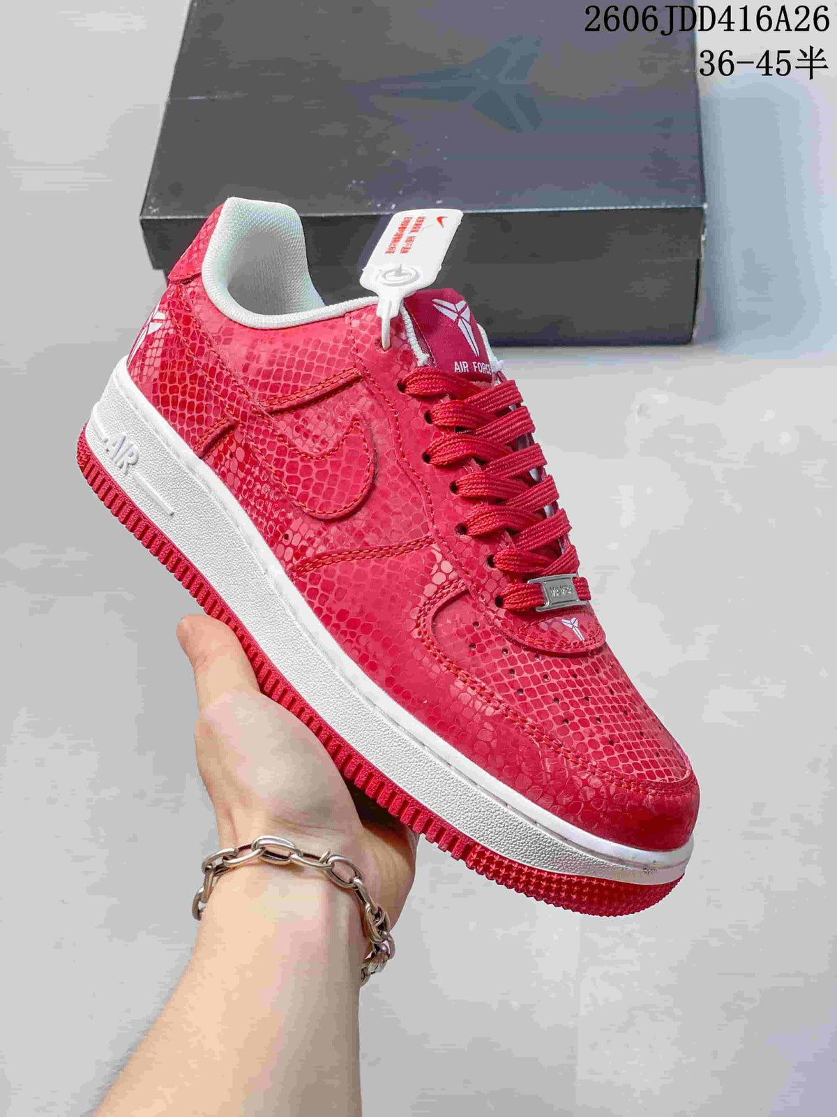 Close-up side view of a red textured low-top Nike Air Force 1 '07 sneaker with a white midsole.