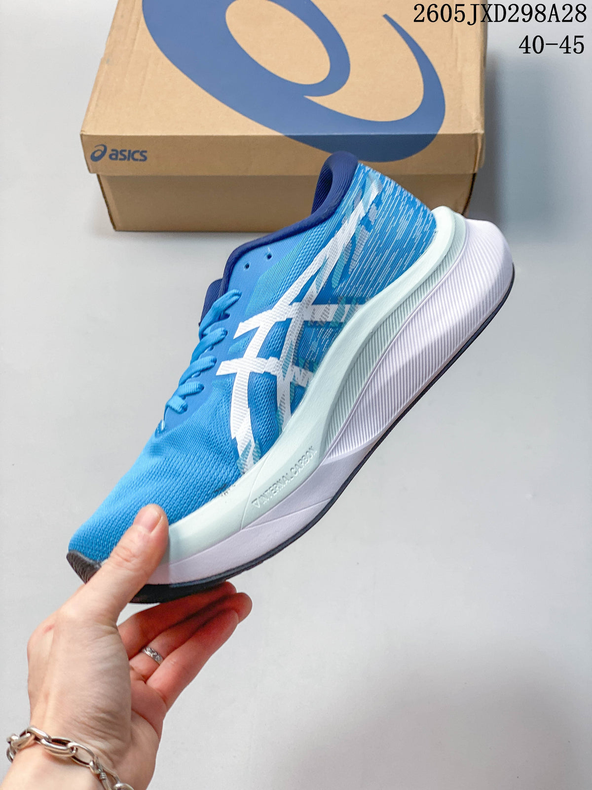 Side view of a blue ASICS Magic Speed 4 running shoe