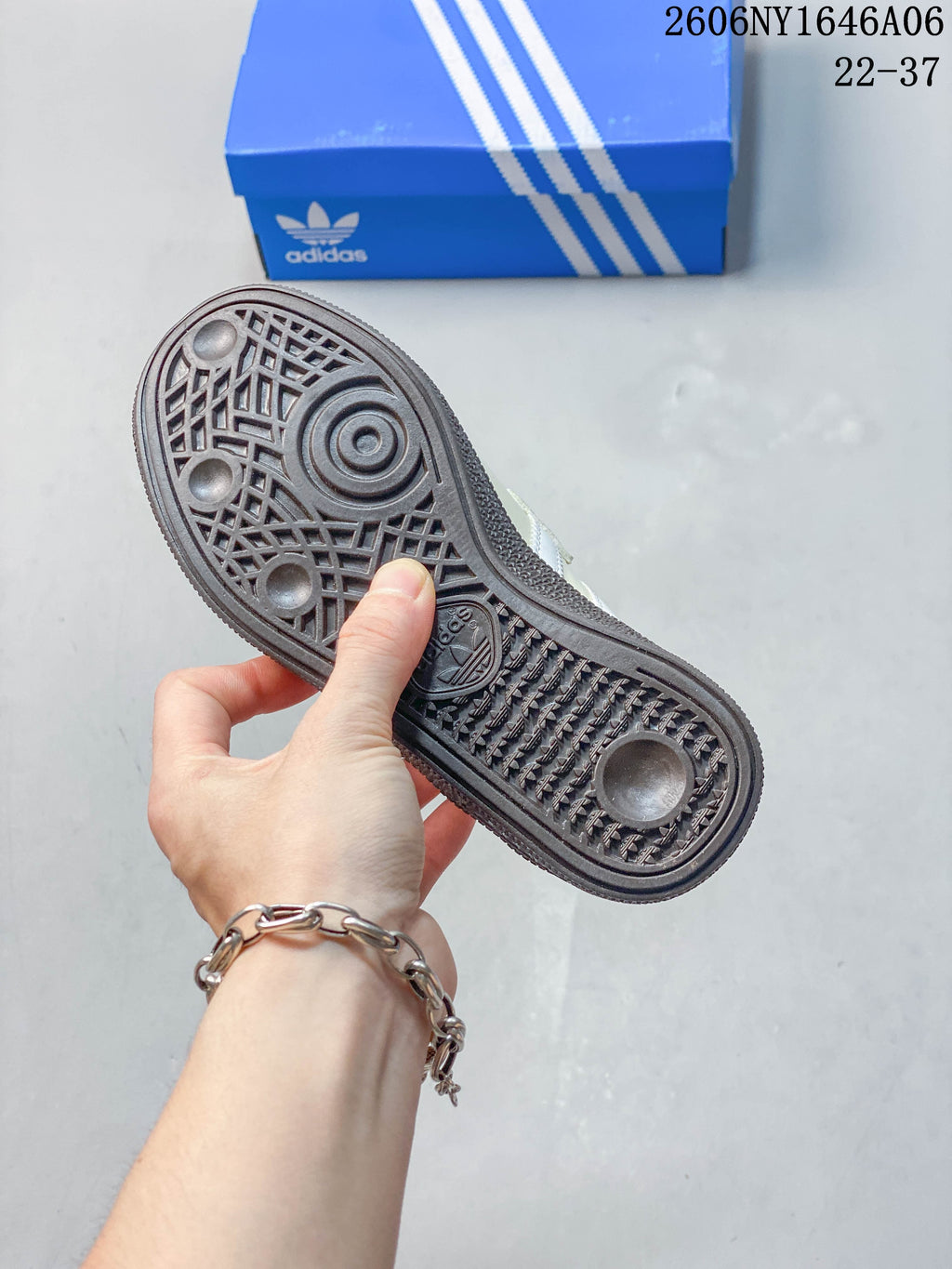 Underside of a shoe showing a patterned dark outsole