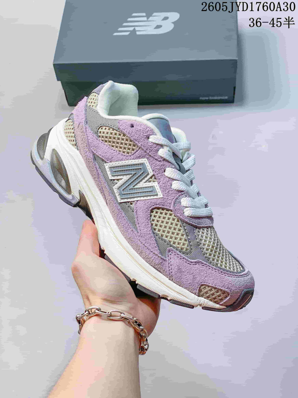 Angled side view of a lavender and grey New Balance 2010 sneaker.