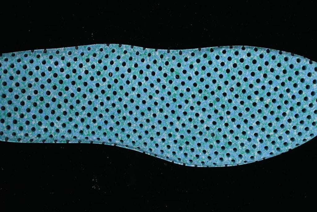 Blue perforated shoe insert shown from above