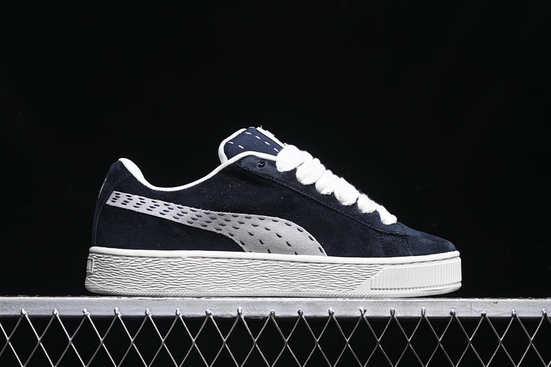 Side profile of the navy sneaker with a light-colored stripe and sole