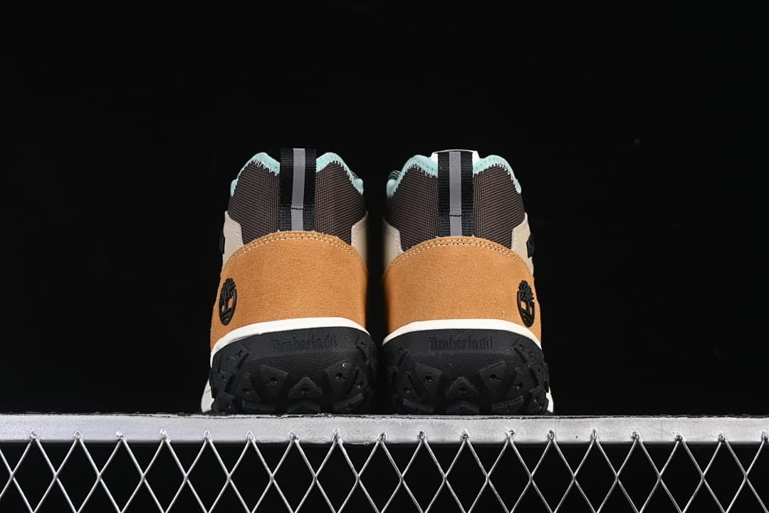 Rear view of the pair showing tan heel panels and black outsoles