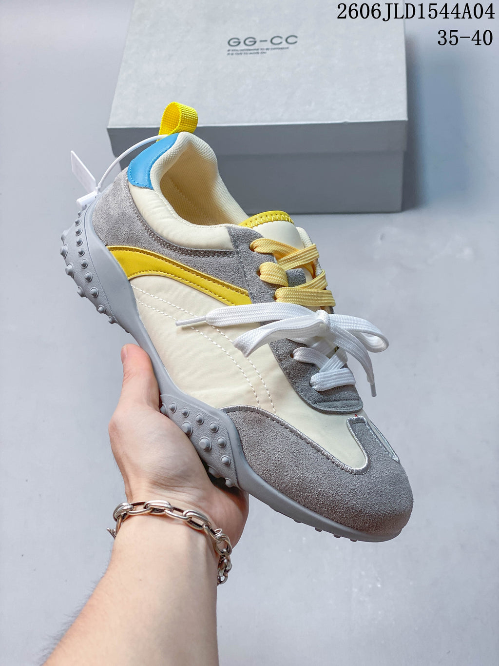 Angled side view of the sneaker showing its color-blocked upper and raised outsole details.