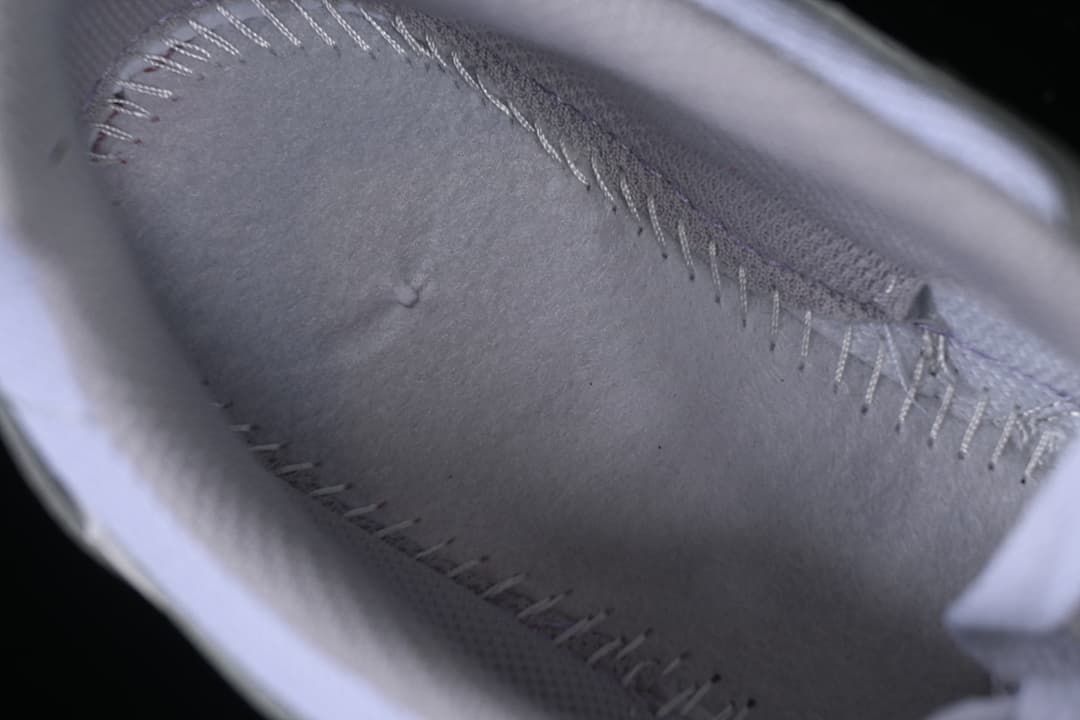 Close-up of the sneaker's light grey inner lining and stitching.