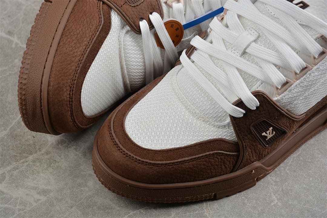 Close-up of the brown toe overlays and white textured upper.