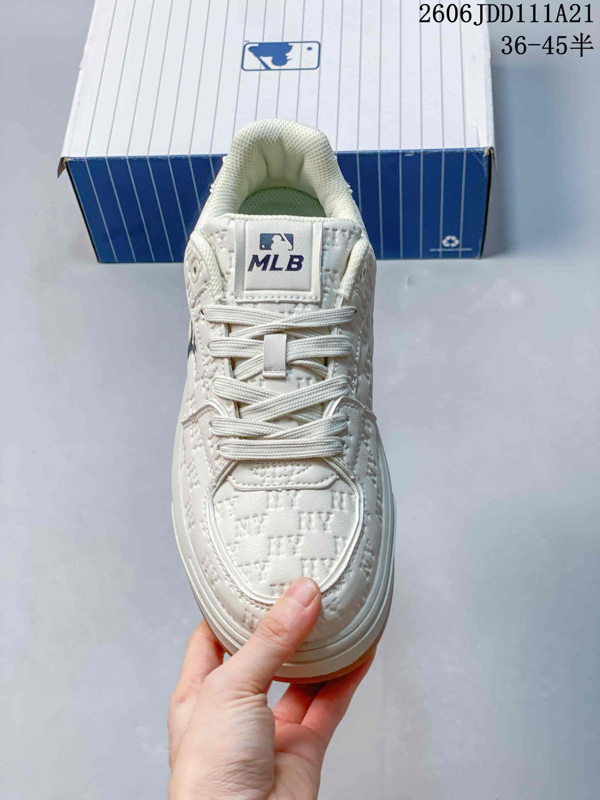 Top view of the ivory sneaker showing its laces and embossed toe pattern