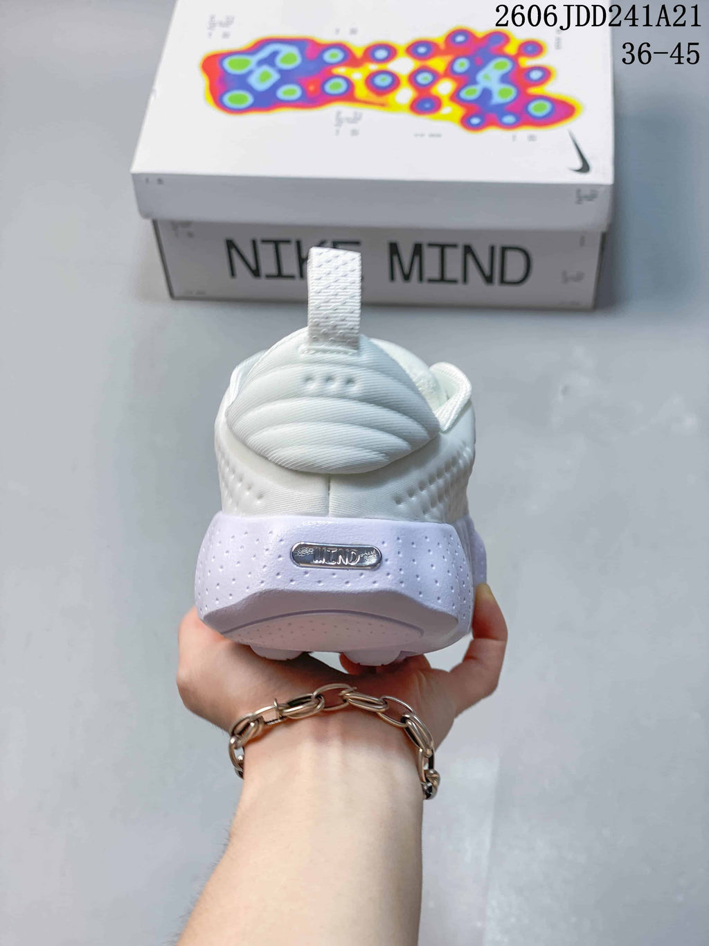 Rear view of a white shoe with a pale lavender heel accent
