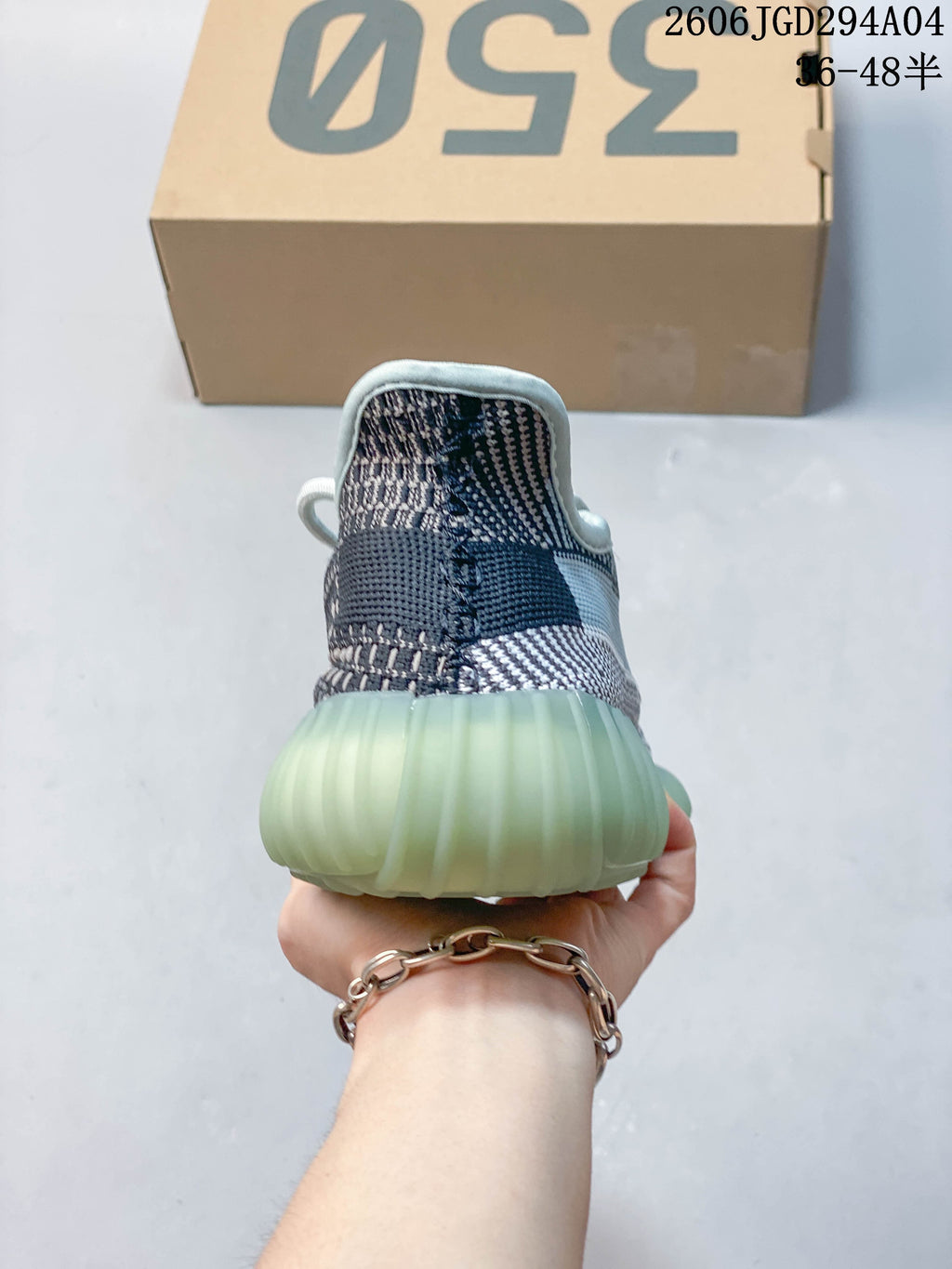 Rear view showing the heel and ribbed pale aqua sole of the sneaker