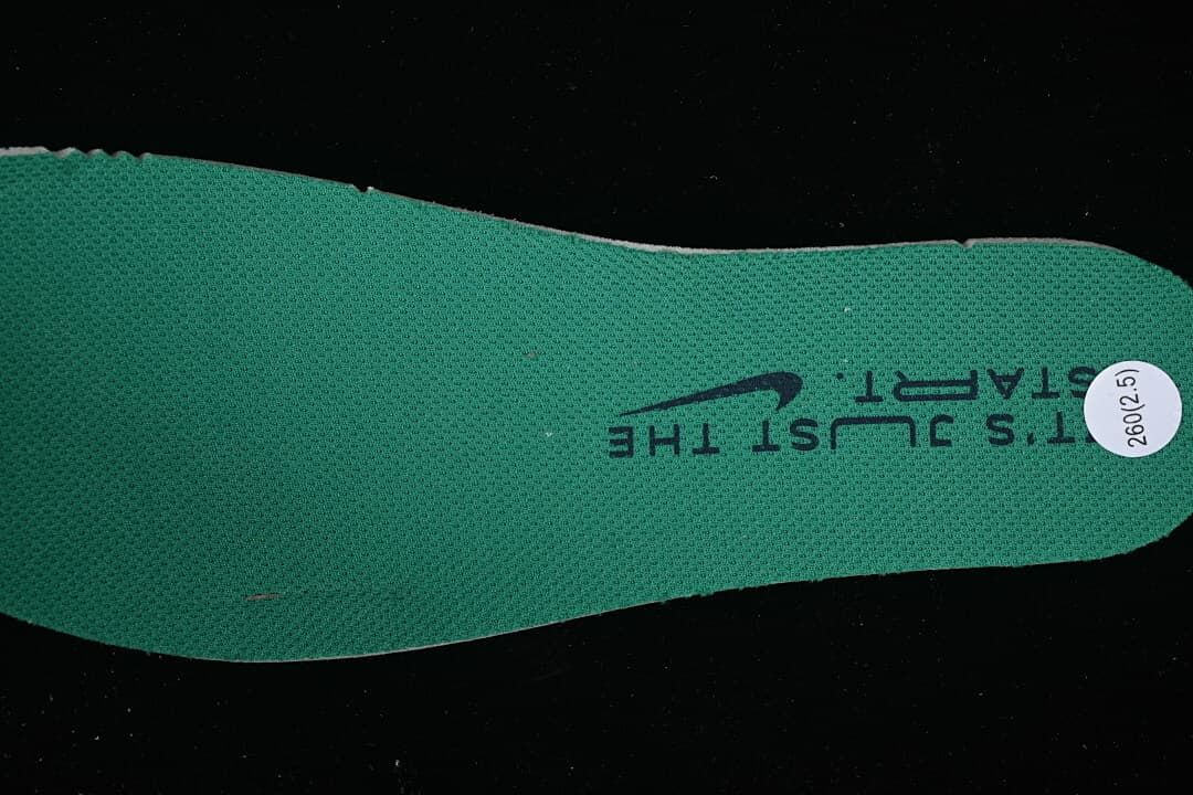 Green shoe insole with printed text and a round size sticker