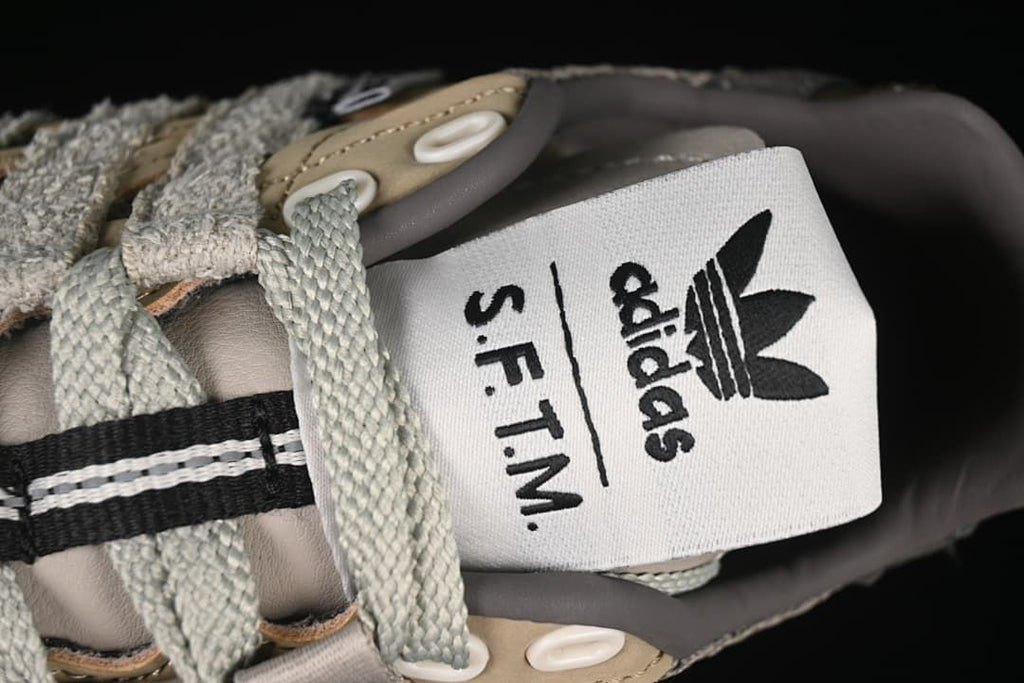 Close-up of the tongue label with adidas and S.F.T.M. branding