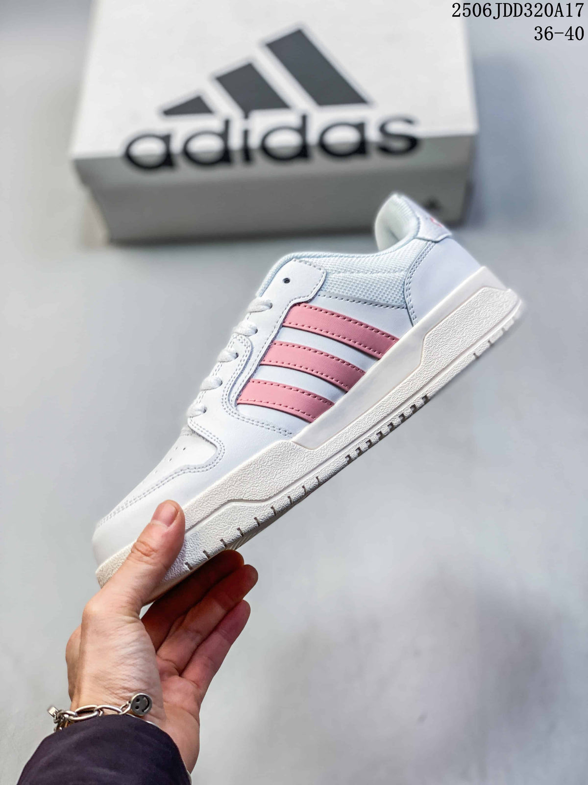 Side profile of the white adidas Entrap sneaker with pink stripes