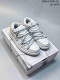 Pair of white and light grey low-top sneakers with gold-colored trim and layered laces