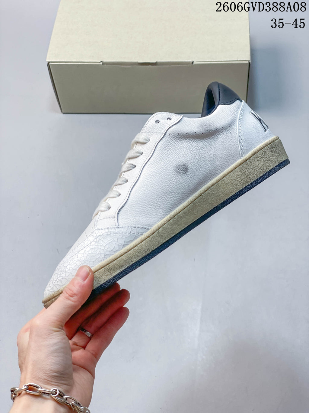Side profile showing the white upper, navy lining and contrasting sole