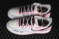 Pair of white and pink low-top sneakers with black accents and decorative graphics