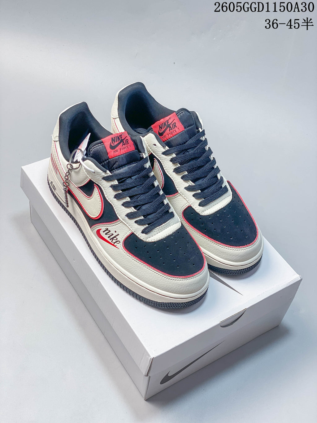 Pair of cream, navy and red low-top sneakers displayed from above