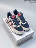 Pair of cream, navy and red low-top sneakers displayed from above