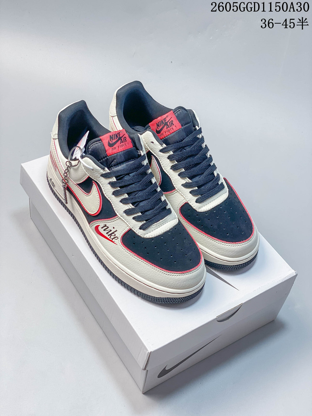 Pair of cream, navy and red low-top sneakers displayed from above