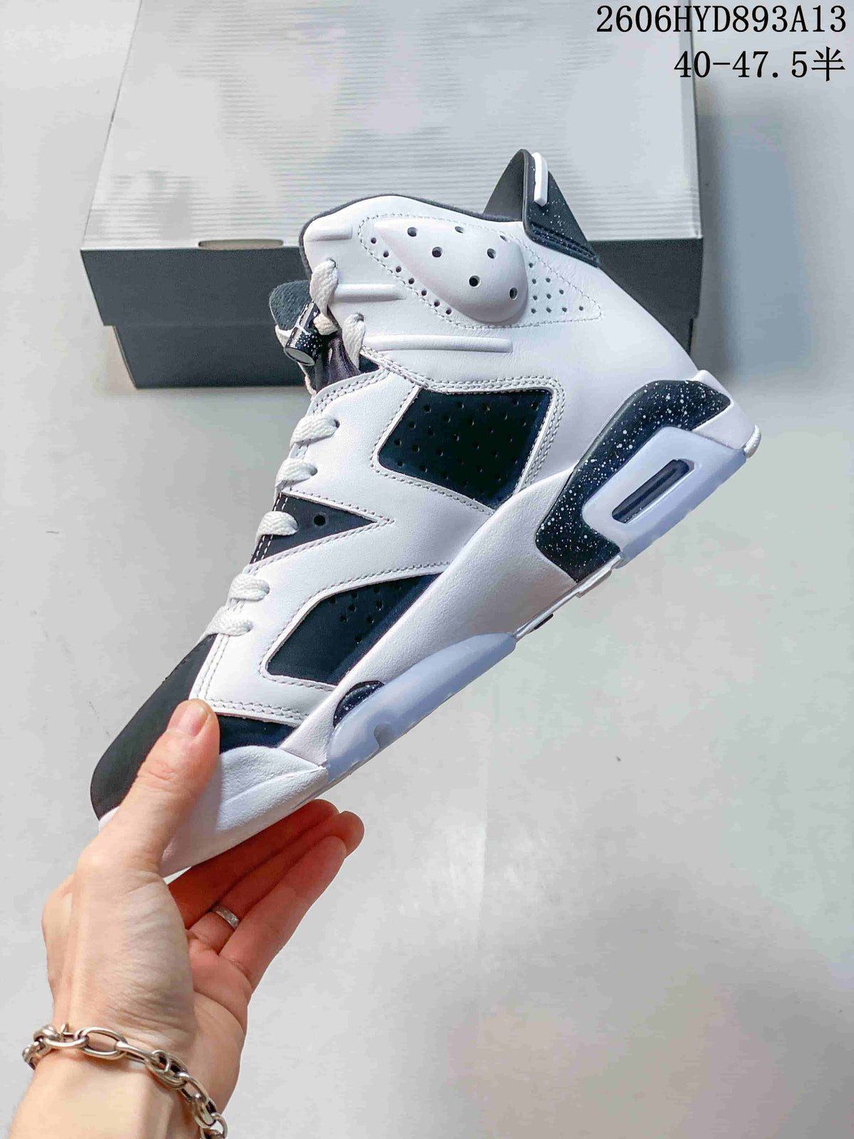 Side profile of the high-top sneaker with perforated panels and speckled accents