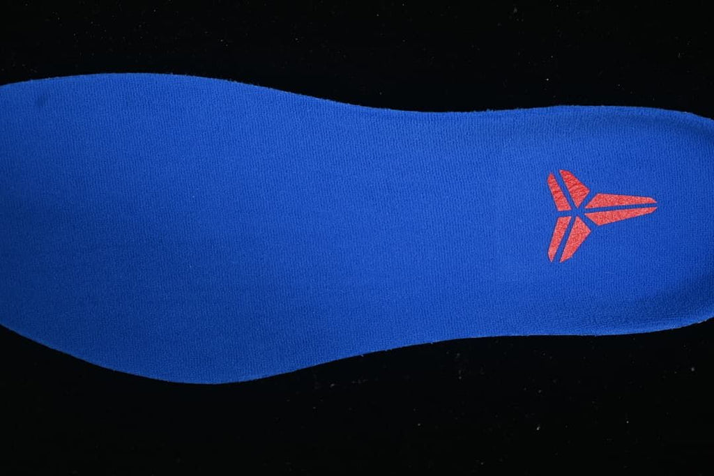 Close-up of a blue shoe insert with a red Kobe logo
