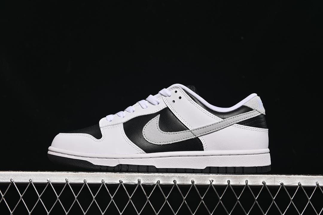 Side view of a black, white, and grey low-top Nike SB Dunk sneaker