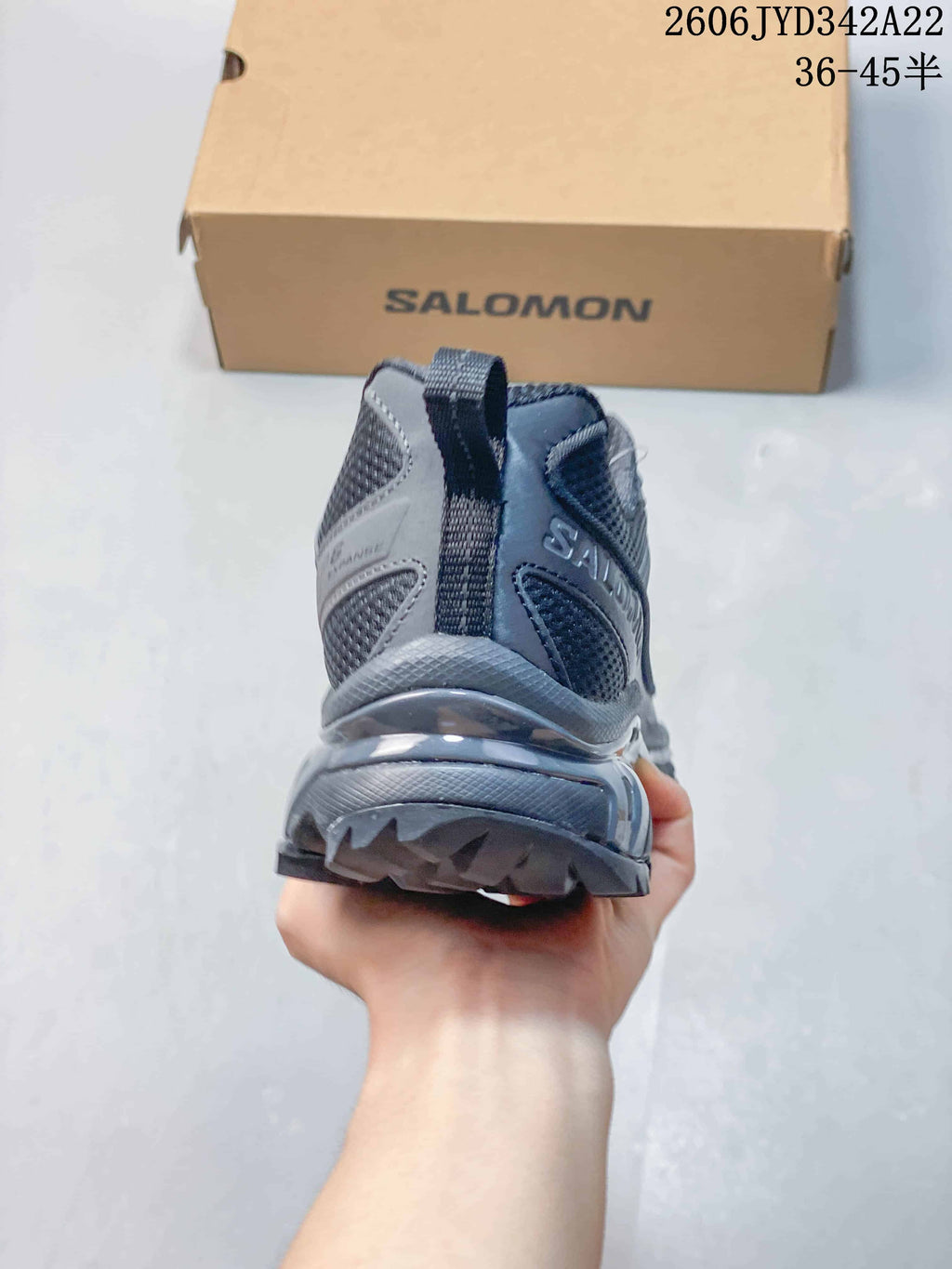 Rear view of the charcoal-gray sneaker with heel pull tab
