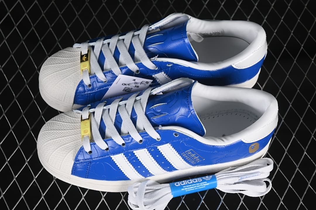 Pair of blue and white sneakers with spare white laces