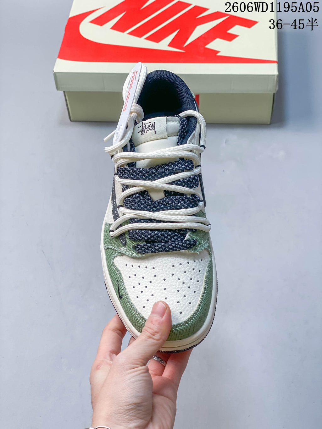 Front view showing perforated white toe panels and patterned navy laces