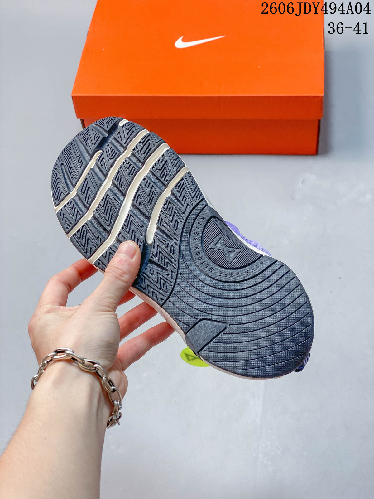 Close-up of the dark patterned outsole on a purple Nike Free Metcon 7 shoe.