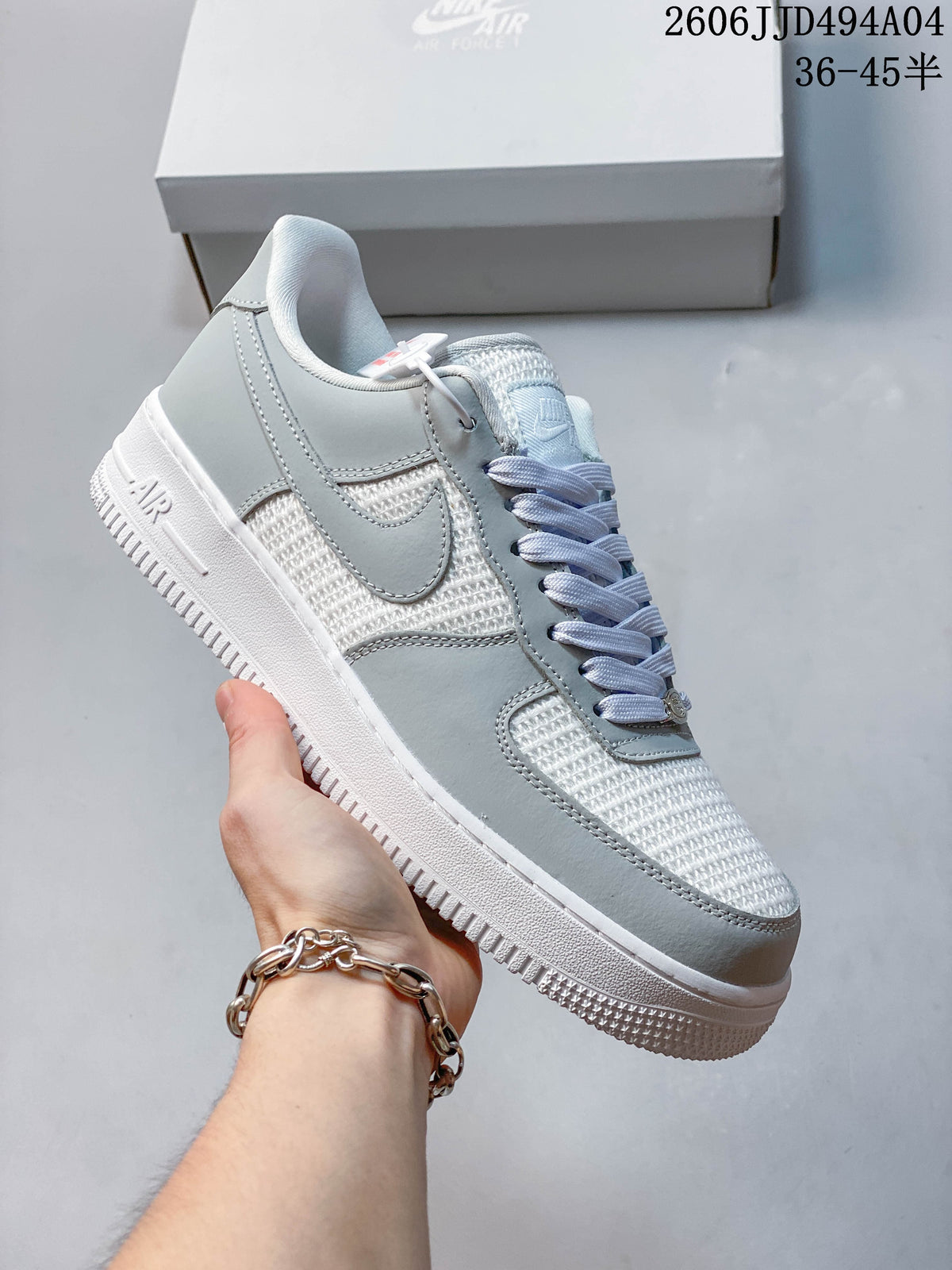 Angled side view of the white and light gray low-top sneaker