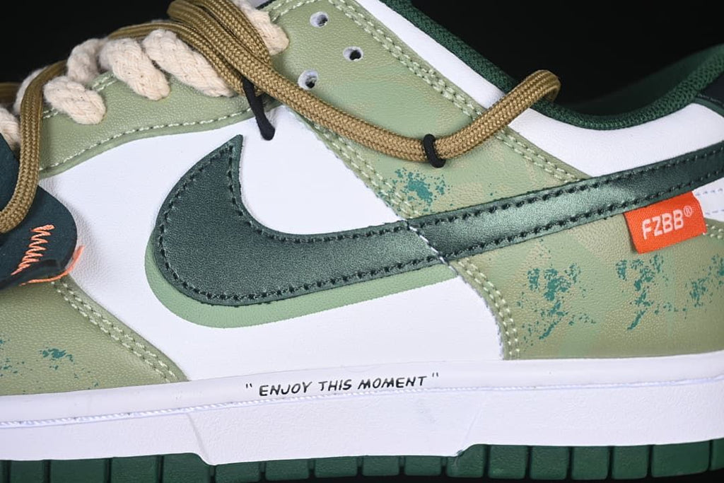 Side detail of the green Swoosh, patterned overlay and midsole phrase