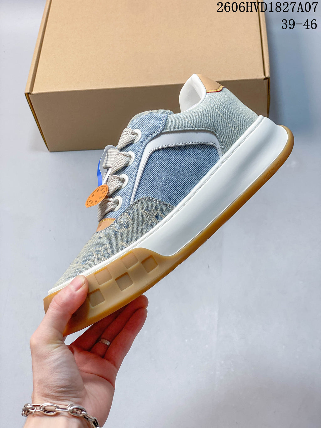 Side profile showing denim-style panels, a white midsole, and gum-colored outsole.