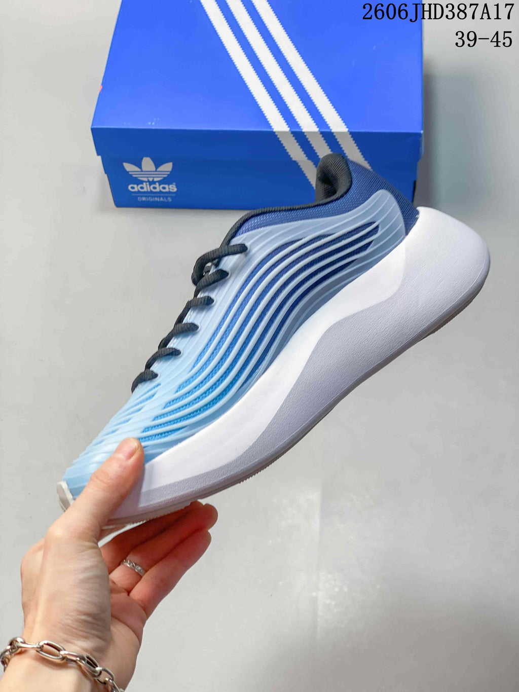 Side view showing the blue ribbed upper and thick white sole