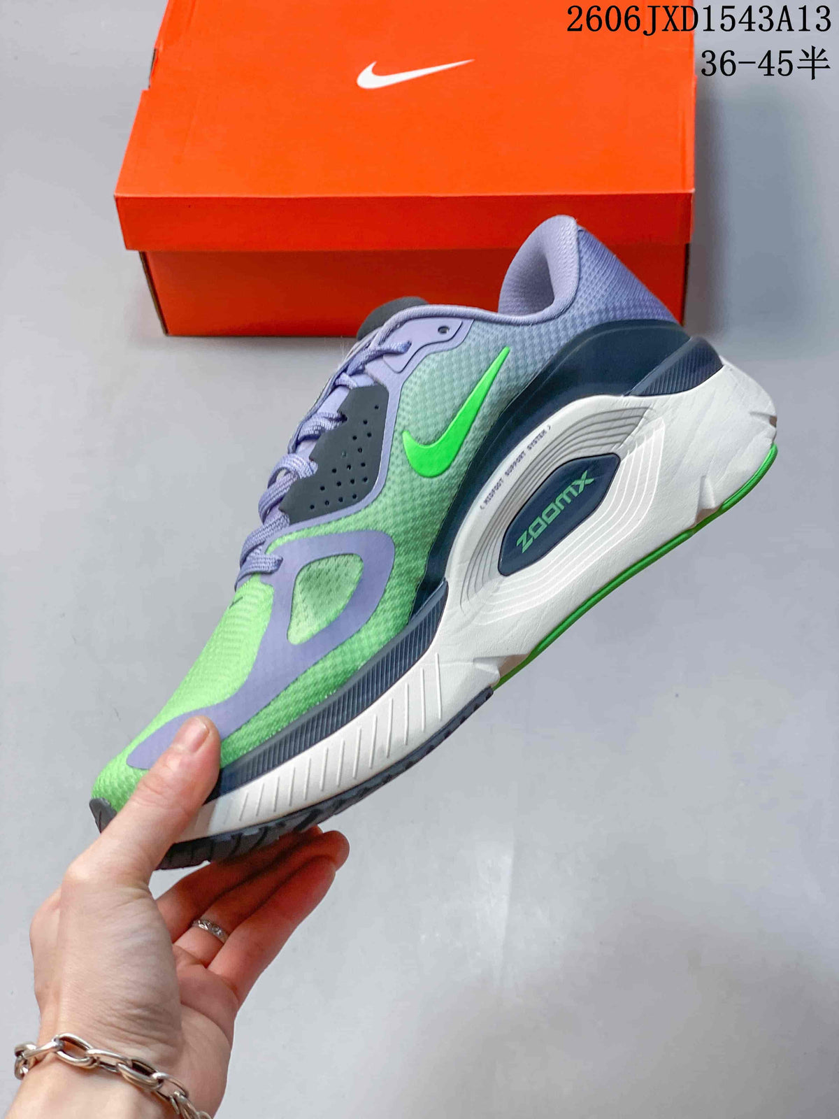 Side view of a green and lavender Nike Structure Plus shoe with visible ZoomX midsole branding.